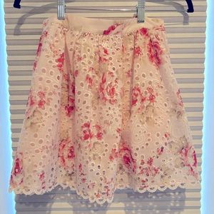 New with tags Aqua eyelet floral print mini skirt. Size small. Back zipper.